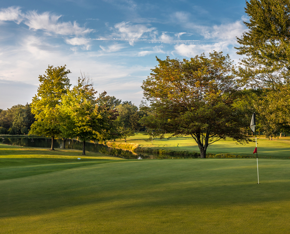 Erie Shores Golf Course - green - golf ball - flag - trees - Lake Metroparks - photo by Andrew Cross